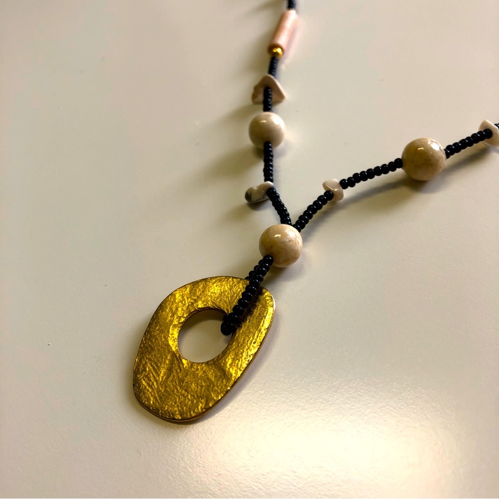 Beaded earth toned necklace with gold-look pendant